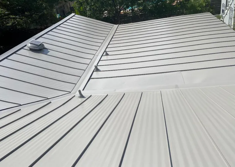 Solar attic fan installed on a metal roof for Roof Ventilation in Cinco Ranch